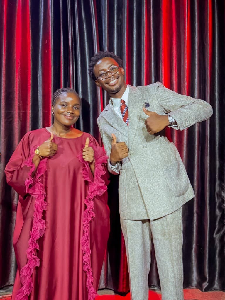 Precious Alo with a ministry partner, both smiling and giving thumbs up